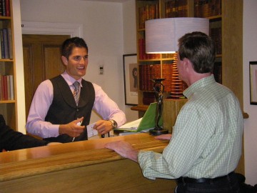 Hotel front desk, staff and guests